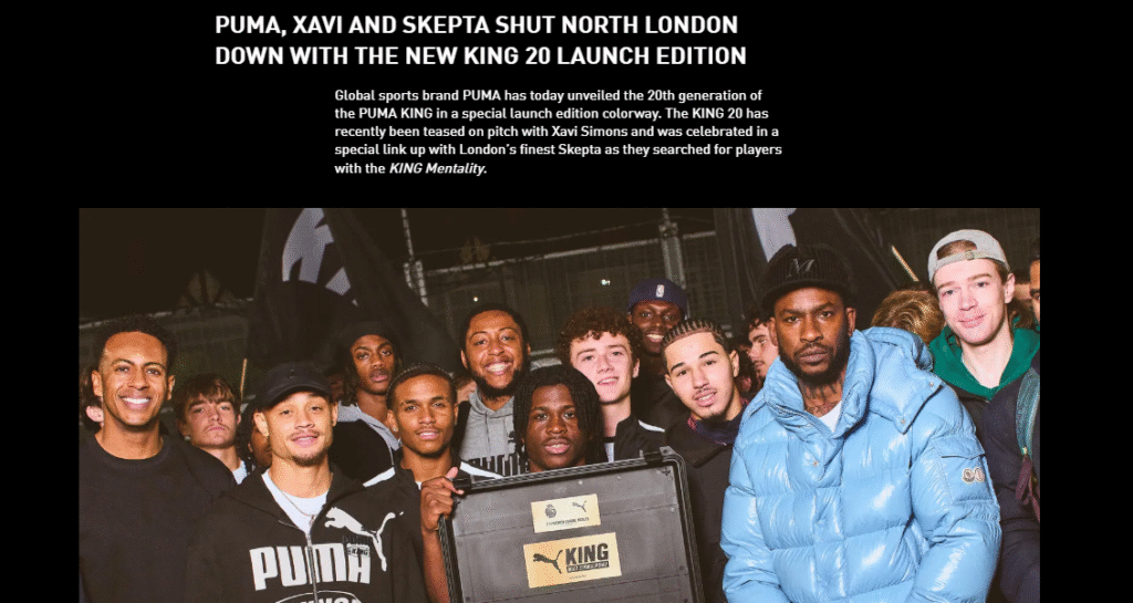 A group of people, including Skepta, pose together holding a PUMA KING 20 Launch Edition case at a promotional event.