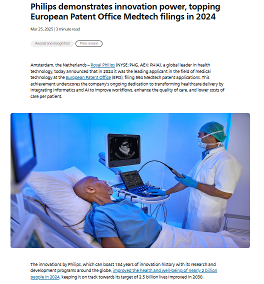 A doctor wearing scrubs uses an ultrasound device on a patient in a hospital bed while viewing the ultrasound image on a monitor.